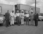 Employees of the meats division of Swift and Company in Montgomery, Alabama, holding front car plates that read "Beef That's Tender Everytime!"