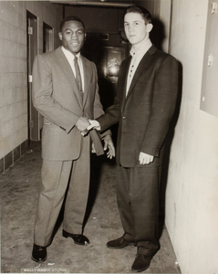 Two unidentified men in suits shaking hands