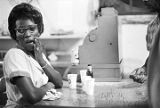 Waitress at Tom's Place at 648 South Holt Street in Montgomery, Alabama, standing behind the counter at the cash register.