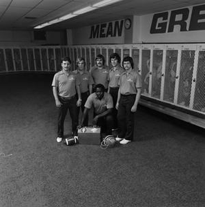 Football staff posing with equipment, 4