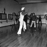 Dance class with instructor in white