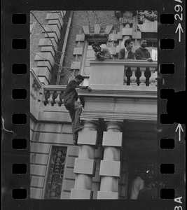 Student climbs up Boston University administration building during sit-in