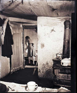 Interior with woman in background: black-and-white photonegative.