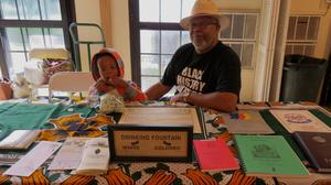 Worker and young boy at AAMD booth