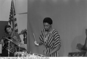 Photograph of drummer performing with band mates at conference for Black Women in the Arts