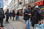 People crowding in front of Checks Cashed, 302 Malcolm X Blvd., Harlem