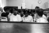 Man explaining scientific equipment to a group of students from Lee County, Alabama, during a field trip to Auburn University.