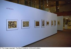 Photograph of an African gallery wall, featuring seven abstract art works