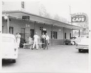 Mississippi State Sovereignty Commission photograph of four males standing outside of Stanley's Cafe and the Trailways Bus Depot, Winona, Mississippi, 1961 November 1