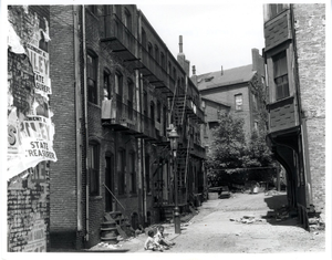 Two children sitting in an alley, Hayden Terrace, Roxbury, Mass., 1957