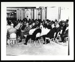 Audience around tables at an unidentified COGIC conference