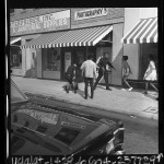 Police officers and youths during disturbance near Los Angeles Manual Arts High School, 1967