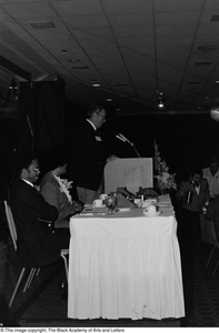 Photograph of Jack Evans standing at a podium at his breakfast conference