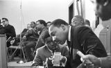 Martin Luther King, Jr., seated and speaking to a young man during a meeting at Maggie Street Baptist Church in Montgomery, Alabama.