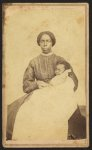 [Full-length portrait of an African American woman seated holding an African American infant]