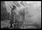 Negro flood refugee washing clothes in the camp at Forrest City, Arkansas