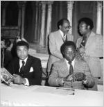 Muhammad Ali, State Senator Leroy Johnson, and Hand Aaron at a press conference, Atlanta, Georgia, August 1980.