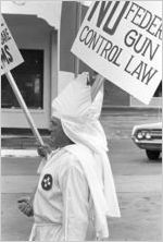 Klansmen carrying signs in a parade during a Ku Klux Klan rally in Montgomery, Alabama.