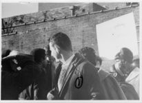 Mississippi State Sovereignty Commission photograph of Tougaloo College student Phillip O'Mara standing in the center of a crowd of unidentified demonstrators during an Anti-Vietnam War demonstration protesting Secretary of Defense Robert McNamara's visit to Jackson, Mississippi, 1967 February 24