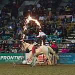 A member of the Westernaires, a Jefferson County, Colorado, organization that teaches and employs Roman-style riding (a rider standing atop two galloping horses) perform at the Martin Luther King, Jr., African-American Heritage Rodeo, one of the National Western Stock Show events in Denver, Colorado