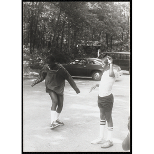 Two children dancing in a circle outside