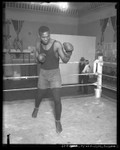 African American Vic Alexander shadow-boxing in ring, circa 1920