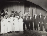 Group photographed in formal wear on a dance floor