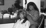 Baby Doll's Hair Design owner posing with a client, Los Angeles, 1989