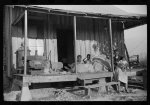 [Untitled photo, possibly related to: Home of Negro wagehand, Knowlton Plantation, Perthshire. On the porch are sacks of cotton. Mississippi, Delta Mississippi]