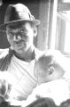 Percy Jones, Jr., holding his daughter Barbara in his home on Clayton Alley in Montgomery, Alabama.