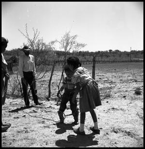 Jack Newcomb Holding a Rope Attached to a Child