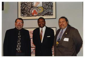 Three Men in Front of Artwork by Rolando Briseno