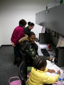 Child and caregiver at computers in Multicultural Center office