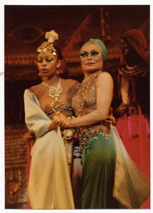 Performance picture of Eartha Kitt (green turban) and a woman]. [color photoprint