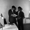 Ralph Nader speaking with a young man while visiting Auburn University.