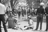 Young civil rights demonstrators pointing at the fire fighters who had sprayed them with a hose in Kelly Ingram Park during the Children's Crusade in Birmingham, Alabama.