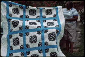 Fabric arts: Ruby Merritt. Ruby Merritt holds up her blue and white Bow Tie quilt.