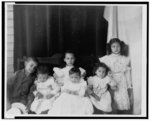 [African American children posed for portrait on a porch]