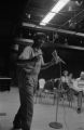 Etheridge Knight: Oxford, Miss. Knight performing at microphone in front of small audience (EKP 3-79-12/11 #296)