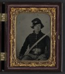 [Unidentified soldier in Union musician uniform and two belts with cavalry saber]