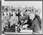 [President Lyndon Johnson, three-quarter length portrait, sitting, facing left, speaking to the nation from the White House prior to signing the Civil Rights Bill into law, while (left to right) Attorney General Robert F. Kennedy, Senate Minority Leader Everett M. Dirksen, Sen. Hubert Humphrey, AFL/CIO Pres George Meany, Rev. Martin Luther King and Rep. Emanuel Celler listen]