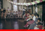 Children sitting on chairs for a party