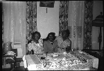 Three women sitting at dining table