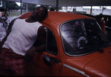 Man leaning on Volkswagen automobile