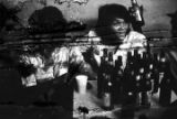 Two women and a man seated at a table at Tom's Place at 648 South Holt Street in Montgomery, Alabama.