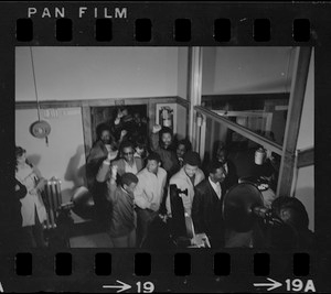 Led by James Moore, Boston State College Black Student Association leader, protesters marched out of the occupied room with their hands clenched in a Black Power salute