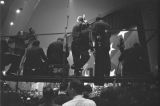 Cameramen and journalists on a platform during a rally in the Municipal Auditorium in Birmingham, Alabama, during Lurleen Wallace's gubernatorial campaign.