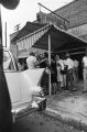 Juanita Jones hugging her sister, Maxine McNair, in front of Social Cleaners across from 16th Street Baptist Church, after the church was bombed.