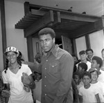 Muhammad Ali and a girl with a baseball glove