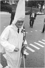 Elderly Klansman holding an American flag at a Ku Klux Klan rally in Montgomery, Alabama.